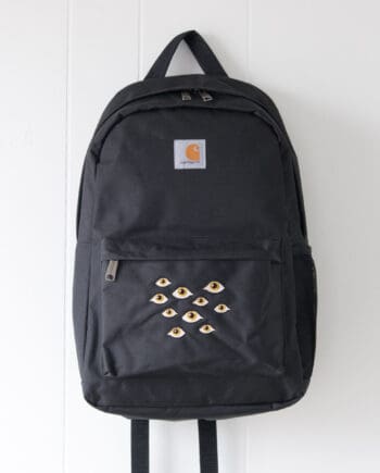Product image - black carhartt backpack embroidered with many eyes design