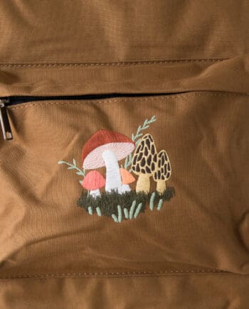 Product image - brown Carhartt backpack with embroidered mushroom design detail