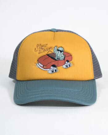 trucker hat with a mesh back in forest green with a mustard yellow front panel embroidered with a cactus wearing sunglasses and waving in a car that is sitting on cinderblocks instead of wheels with the slogan "Slow Down."